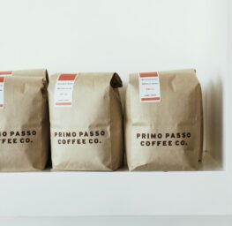 three brown Primo Passo Coffee co packs